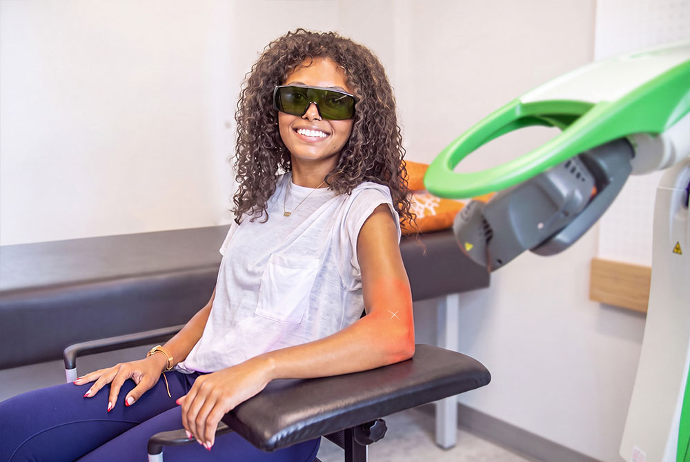 Patient receiving OrthoLazer laser therapy on her arm